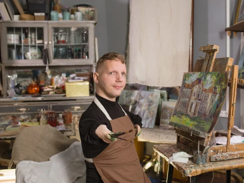Disabled man in art class, painting a picture