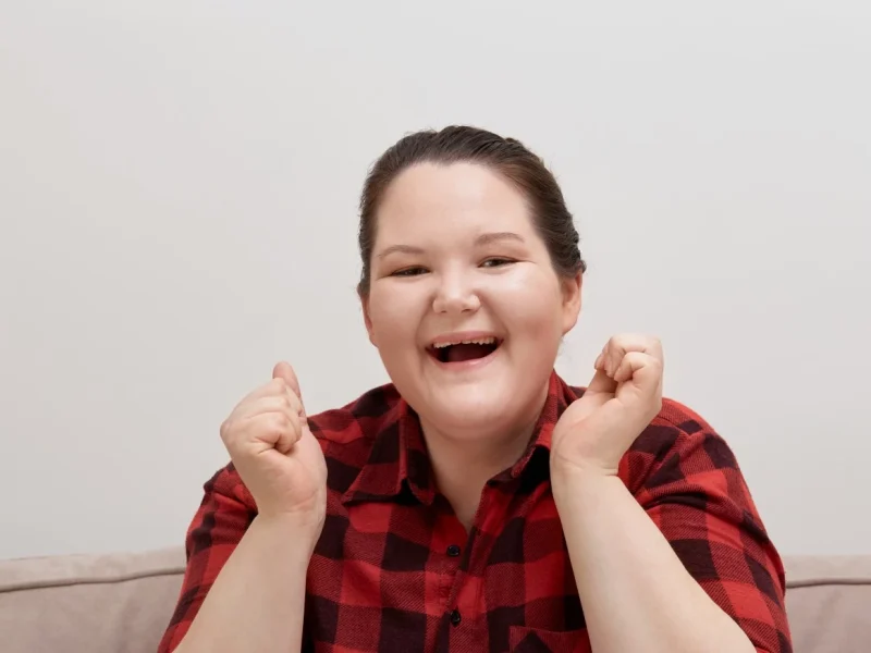 Happy disabled girl smiling and laughing at camera
